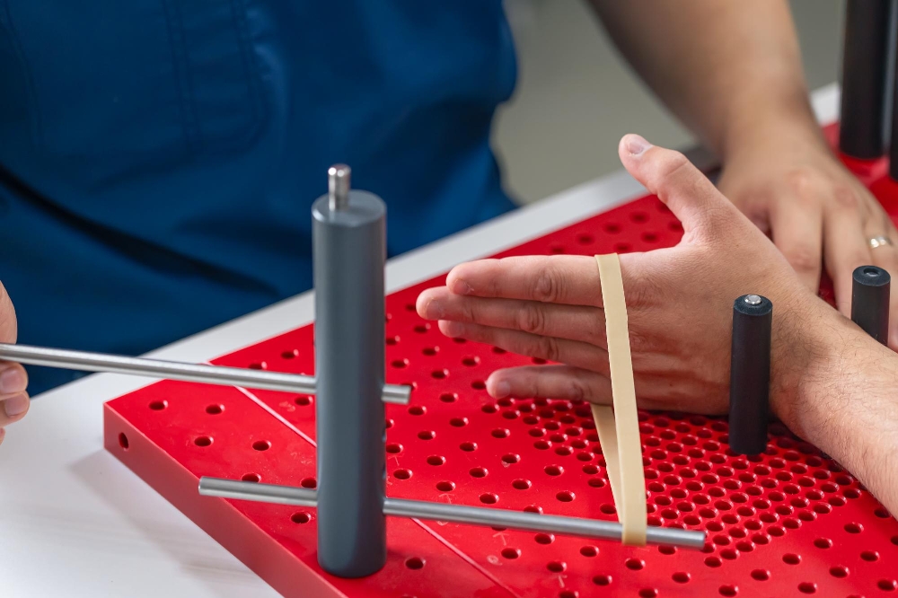 Close-up of a hand exercising on a wrist range-of-motion board during an occupational therapy session.